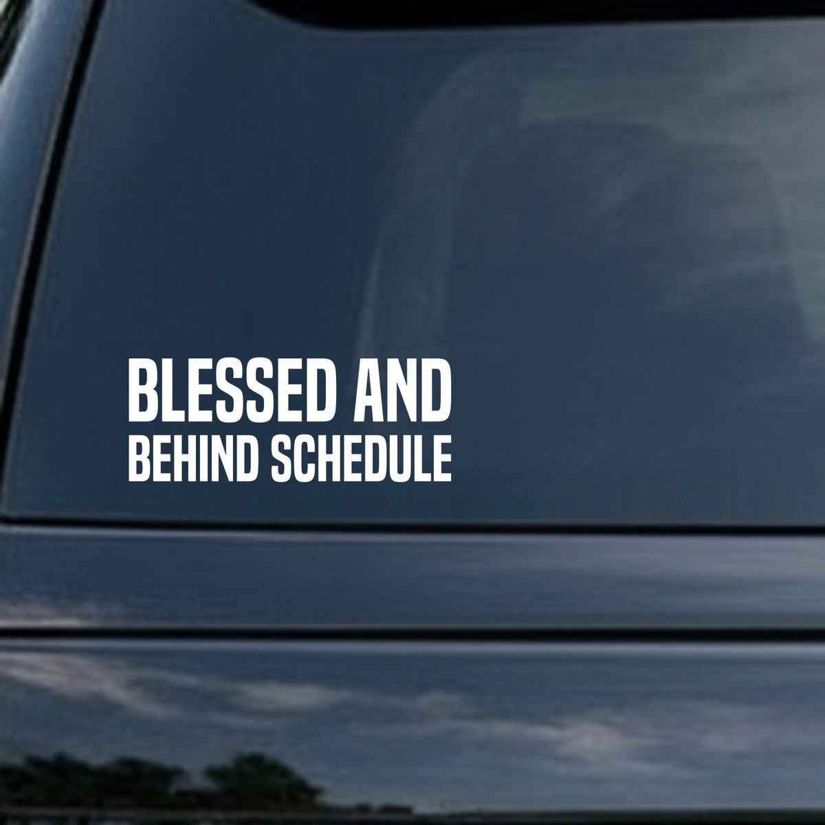 White text reading Blessed And Behind Schedule in bold block letters on a solid black background