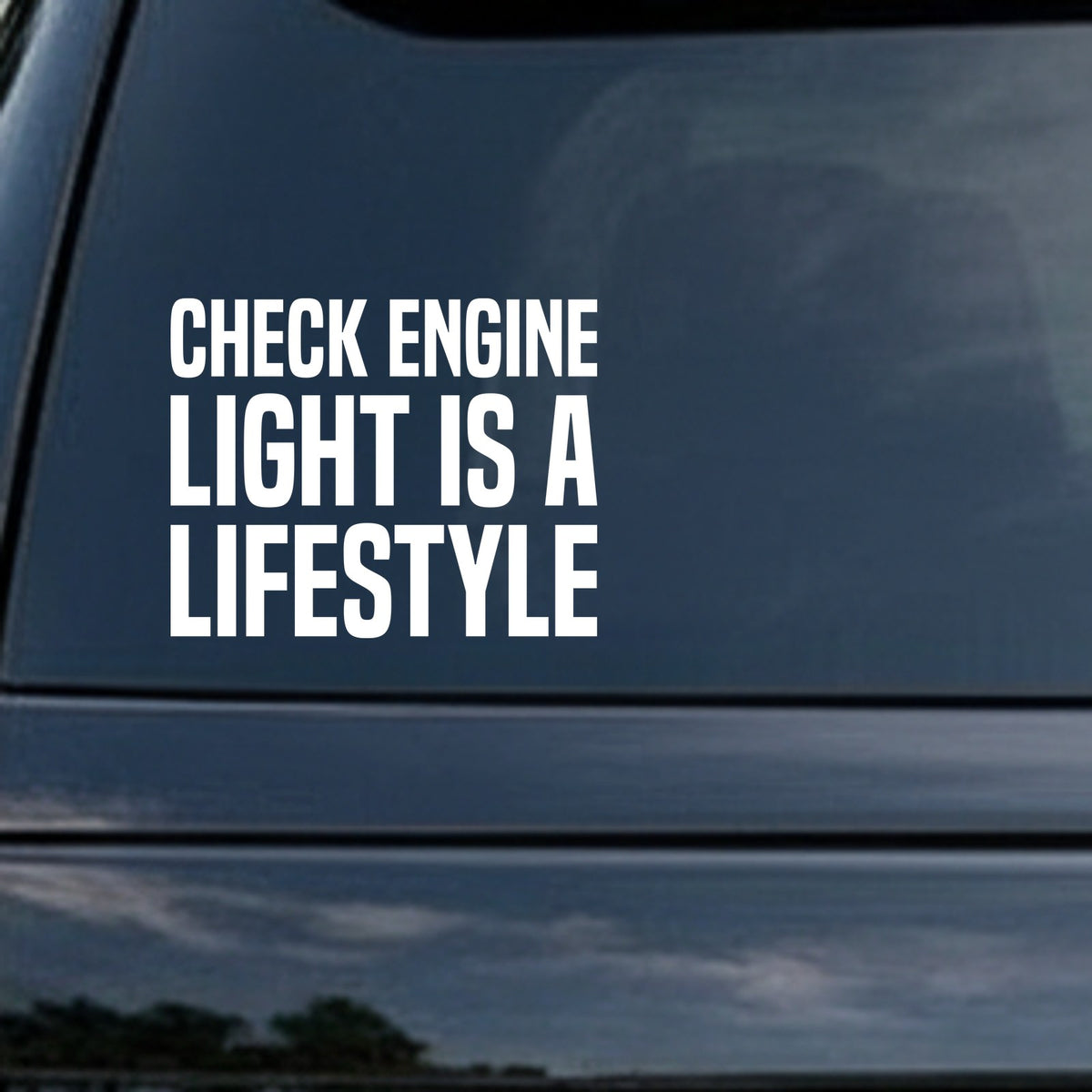 White block letters reading Check Engine Light Is A Lifestyle on a solid black background in all caps.