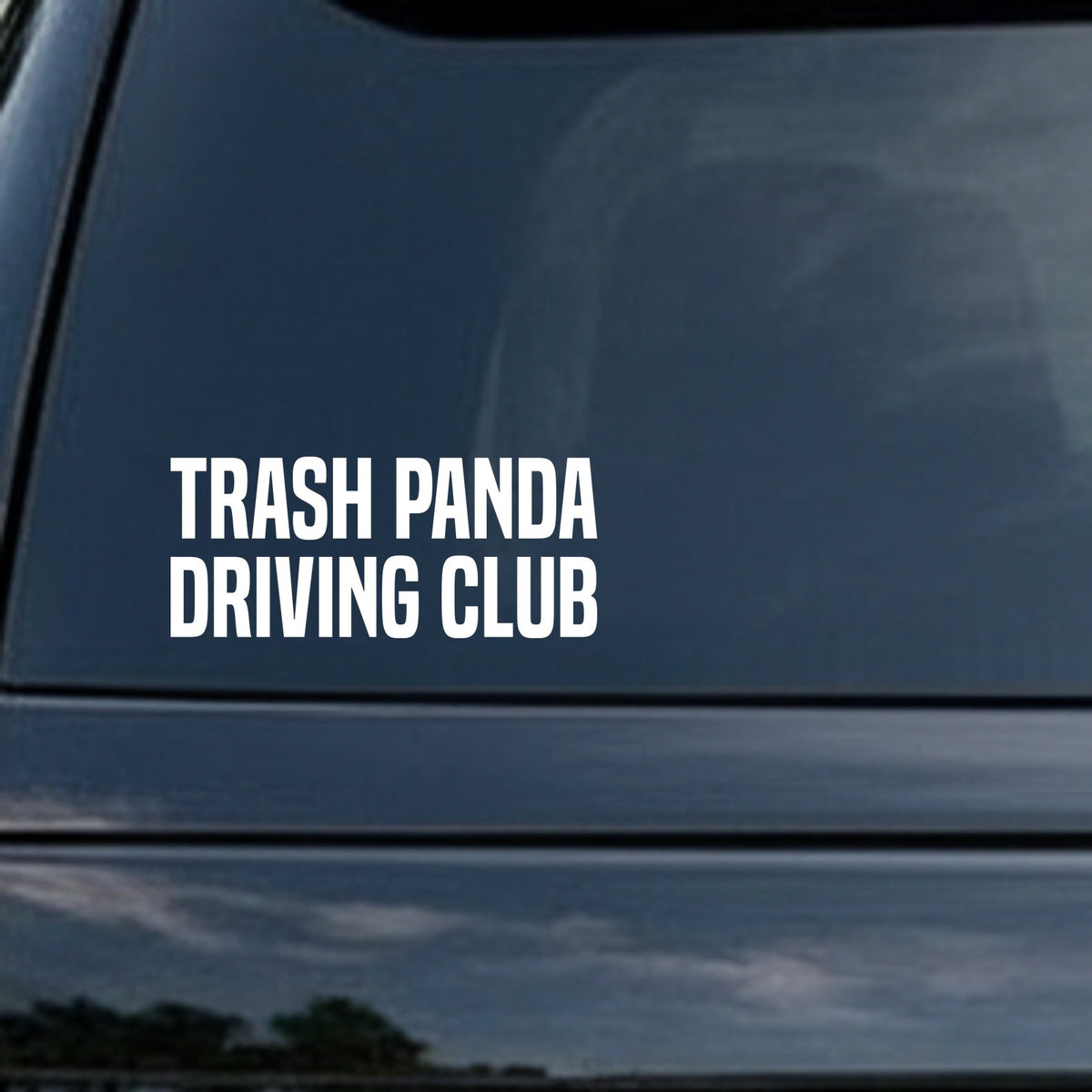 White bold text saying 'Trash Panda Driving Club' on black background in all capital letters, simple block font