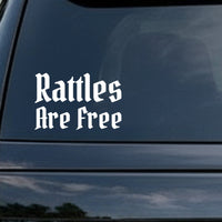 White gothic Old English style lettering saying Rattles Are Free on a solid black background in two lines.