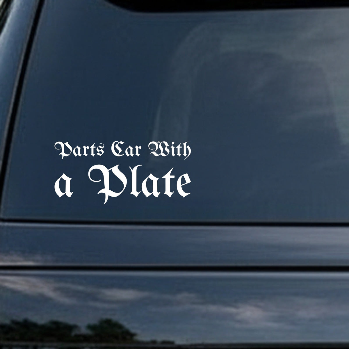 White Gothic Old English style text reading 'Parts Car With a Plate' on a black background, bold lettering style