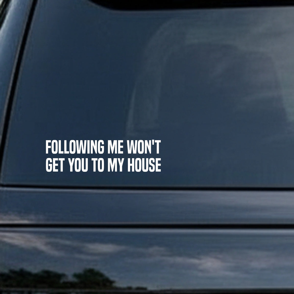 White bold text on black background reading 'FOLLOWING ME WON'T GET YOU TO MY HOUSE' in all caps, simple block style