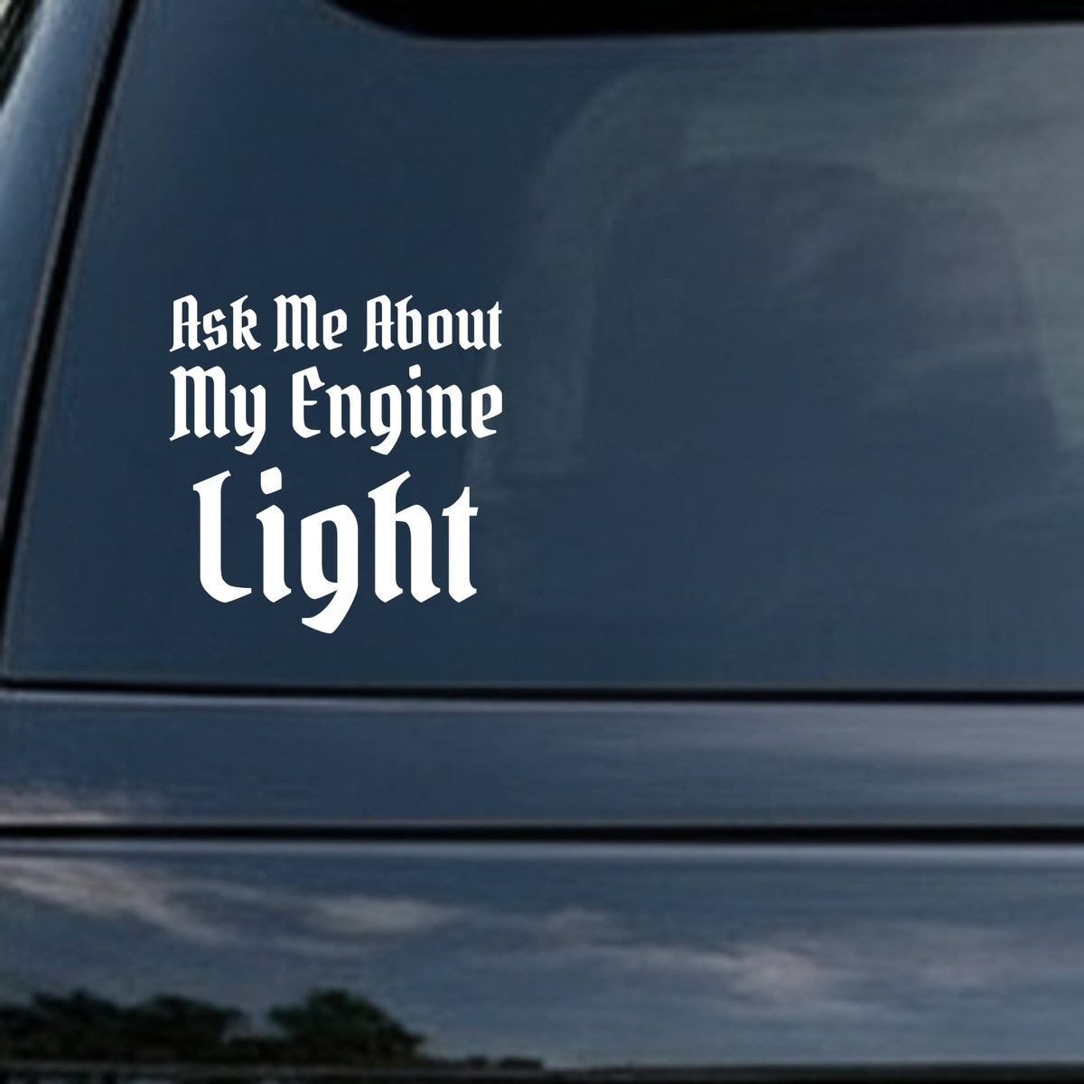 White Gothic Old English font lettering saying Ask Me About My Engine Light on a black background