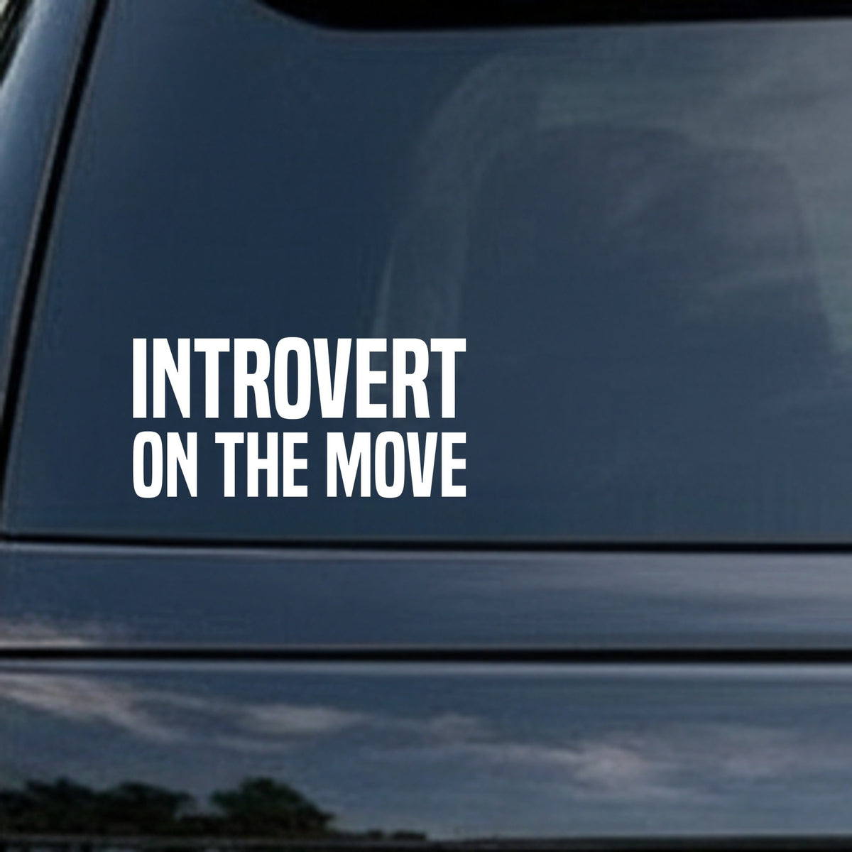 White bold block letters spelling Introvert On The Move on a black background in a simple, modern style.