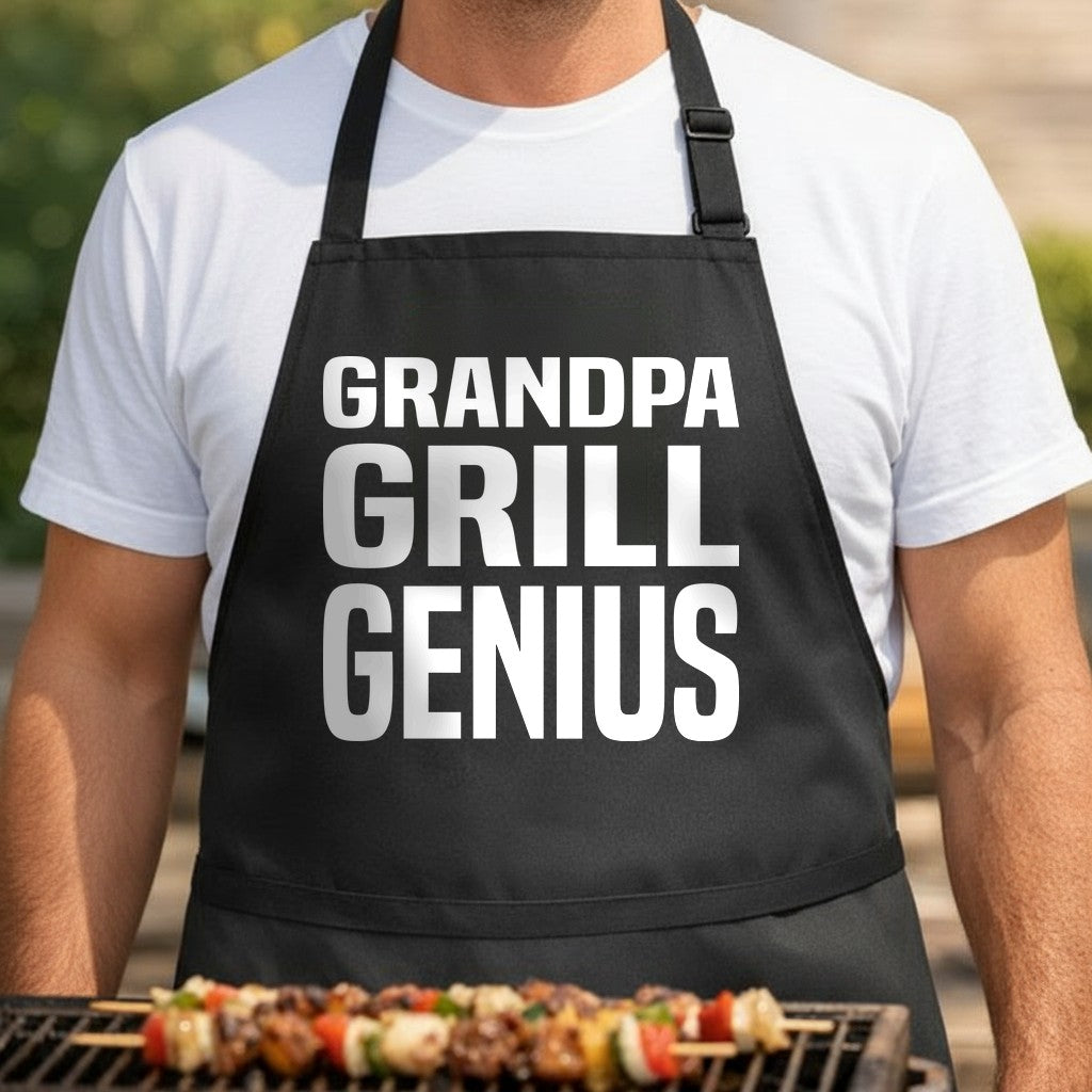 Black apron with large white bold slab font text reading Grandpa Grill Genius in three stacked rows