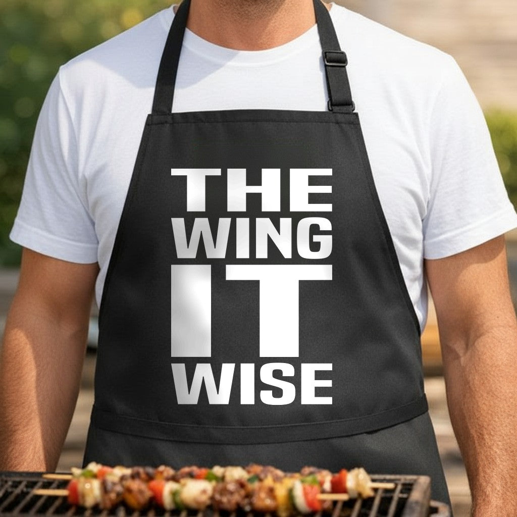 Black apron with large bold white text reading The Wing It Wise in a simple western style font