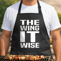 Black apron with large bold white text reading The Wing It Wise in a simple western style font