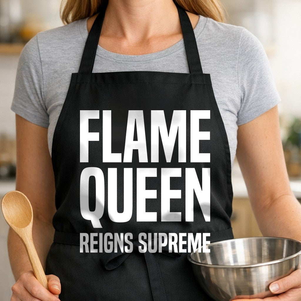Black apron with large white text reading Flame Queen Reigns Supreme in bold block letters.