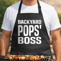 Black apron with large white text saying Backyard Pops' Boss in a bold, simple font style