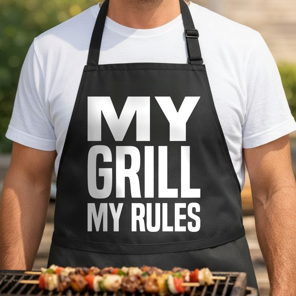 Black apron with large bold white text stating My Grill My Rules in a simple classic font