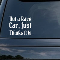White gothic Old English style lettering saying Not a Race Car Just Thinks It Is on black background in a vinyl decal style