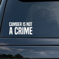 White vinyl decal with bold uppercase text reading 'Camber Is Not A Crime' on a black background in a strong sans-serif font.