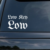 White vinyl decal with the phrase Low Key Low in gothic blackletter font on a black background.
