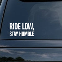 Bold white text saying Ride Low, Stay Humble on a solid black background in a simple, all-caps sans-serif font