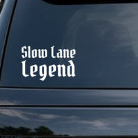 White vinyl decal with the phrase Slow Lane Legend in gothic blackletter font on a black background