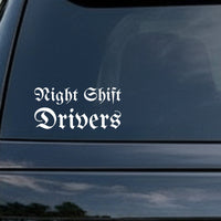 White gothic blackletter Old English font saying Night Shift Drivers on a black background in two lines.
