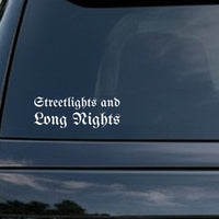 White vinyl decal with the phrase 'Streetlights and Long Nights' in gothic blackletter Old English font on a black background.
