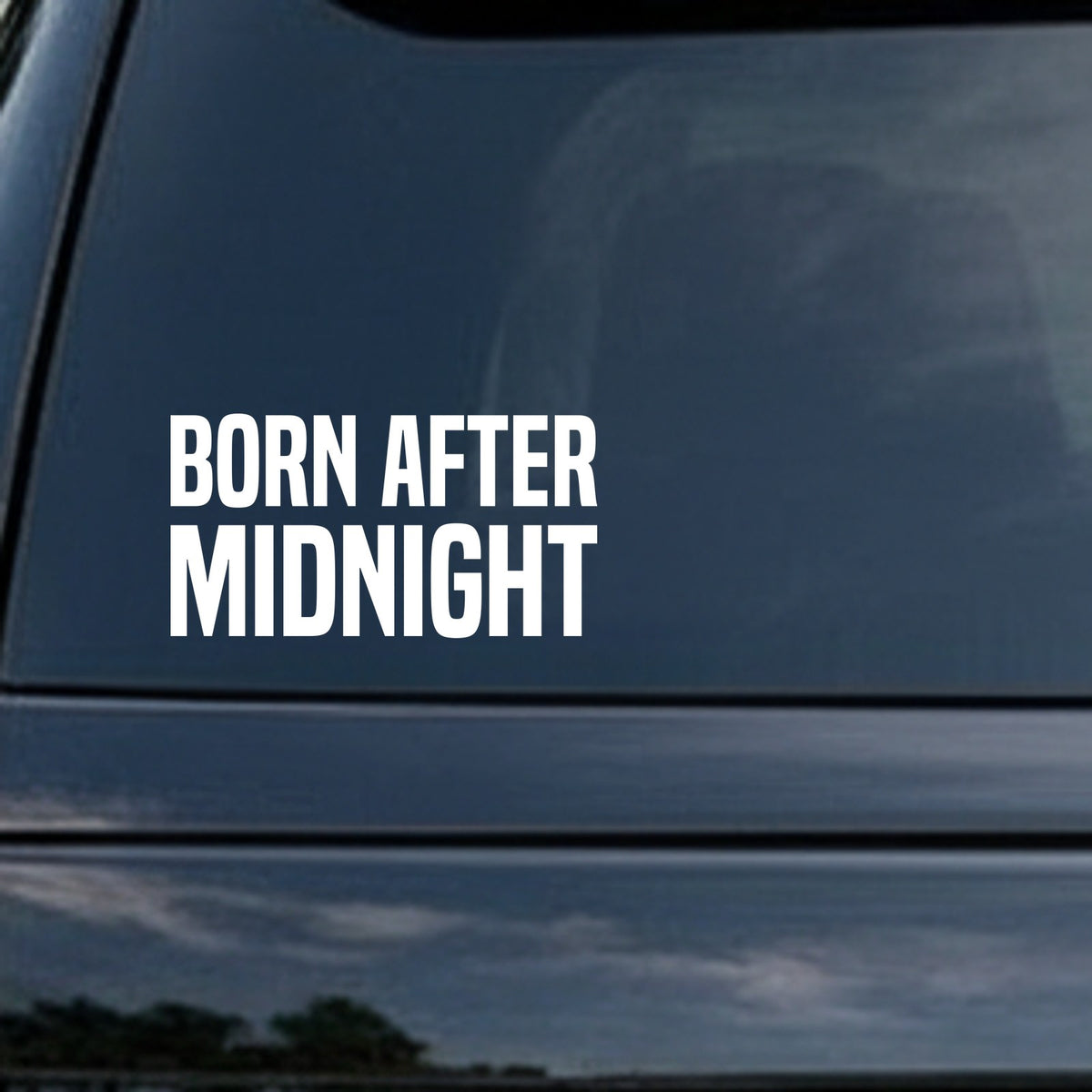Bold white lettering saying Born After Midnight on a black background in a simple block font style