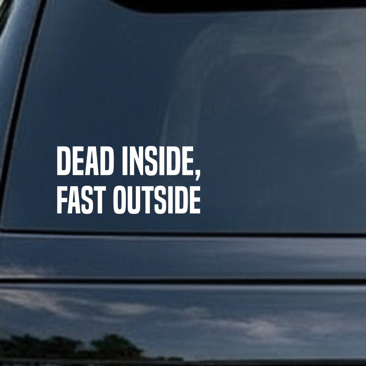 White bold capital letters saying 'Dead Inside, Fast Outside' on a black background in a simple sans-serif font.