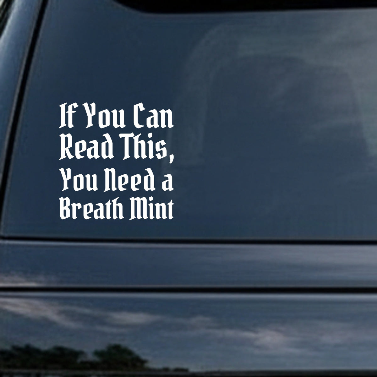 White gothic blackletter text saying If You Can Read This You Need a Breath Mint on a black background