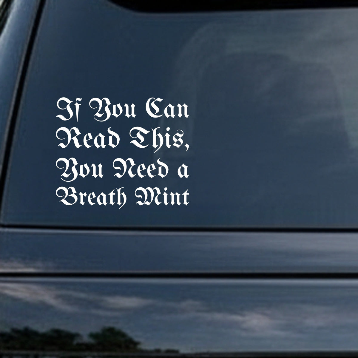 White gothic blackletter font phrase reading If You Can Read This You Need a Breath Mint on a solid black background