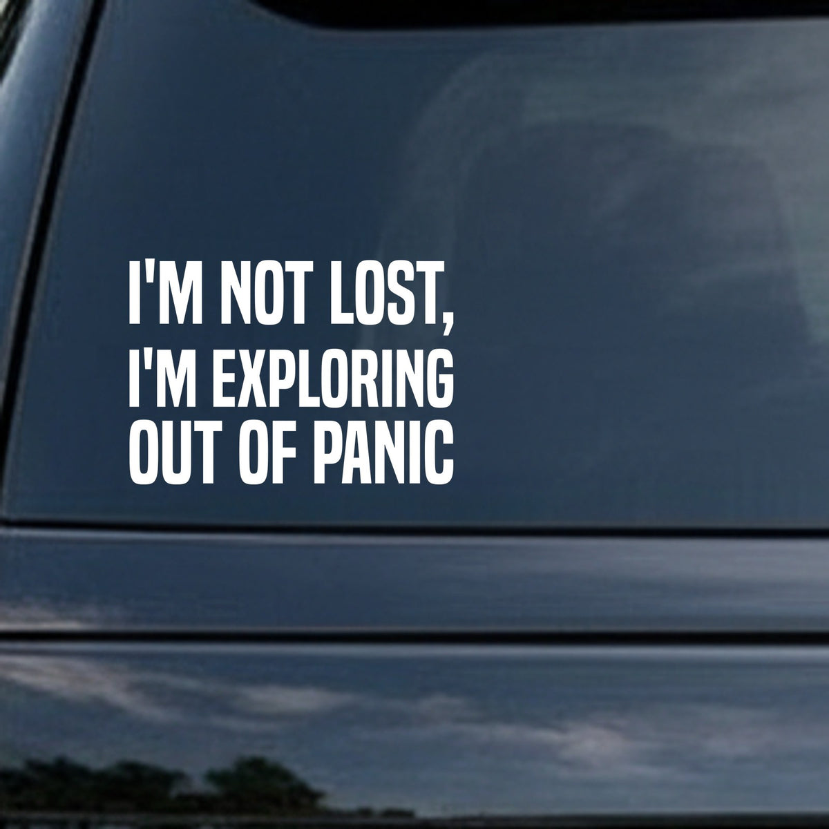 White vinyl decal with bold uppercase text saying I'M NOT LOST I'M EXPLORING OUT OF PANIC on black background