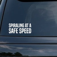 White bold capital letters spelling Spiraling At A Safe Speed on a black background in a simple block font