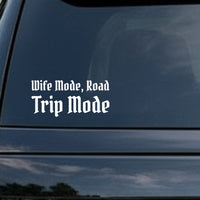 White vinyl decal with the phrase 'Wife Mode, Road Trip Mode' in gothic blackletter Old English style font on a black background