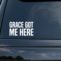 Bold white block letters saying 'GRACE GOT ME HERE' on a solid black background, simple text design
