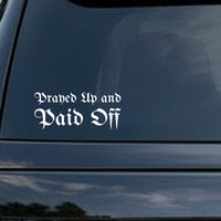 White vinyl decal with gothic blackletter Old English style text reading 'Prayed Up and Paid Off' on a black background