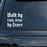 White lettering in gothic blackletter font saying Walk by Faith, Drive by Grace on a black background.