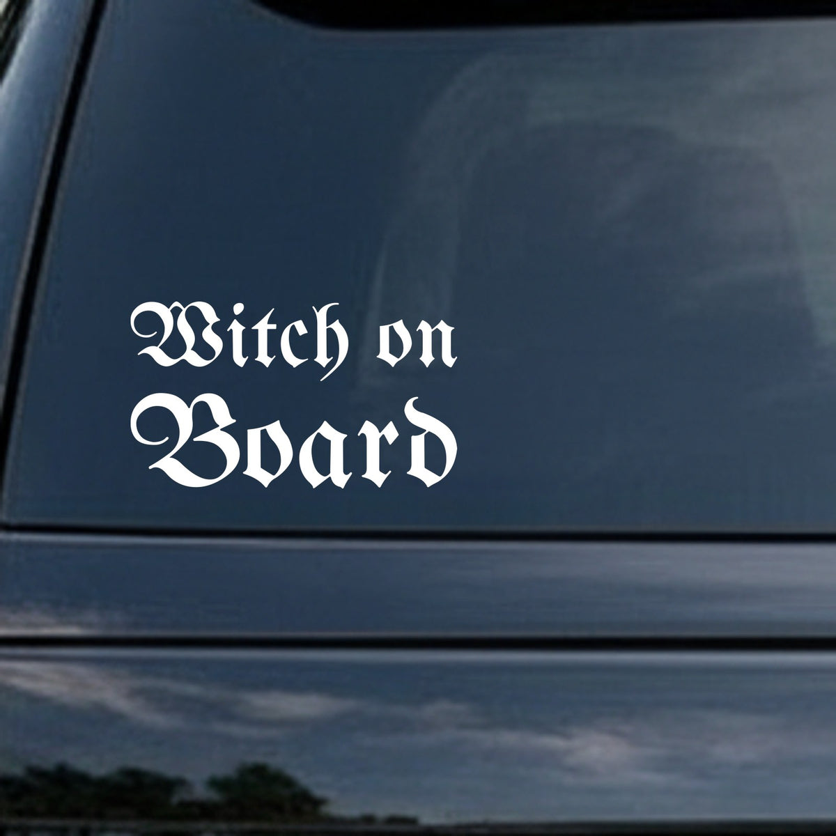 White gothic blackletter lettering saying 'Witch on Board' on a solid black background in Old English style.