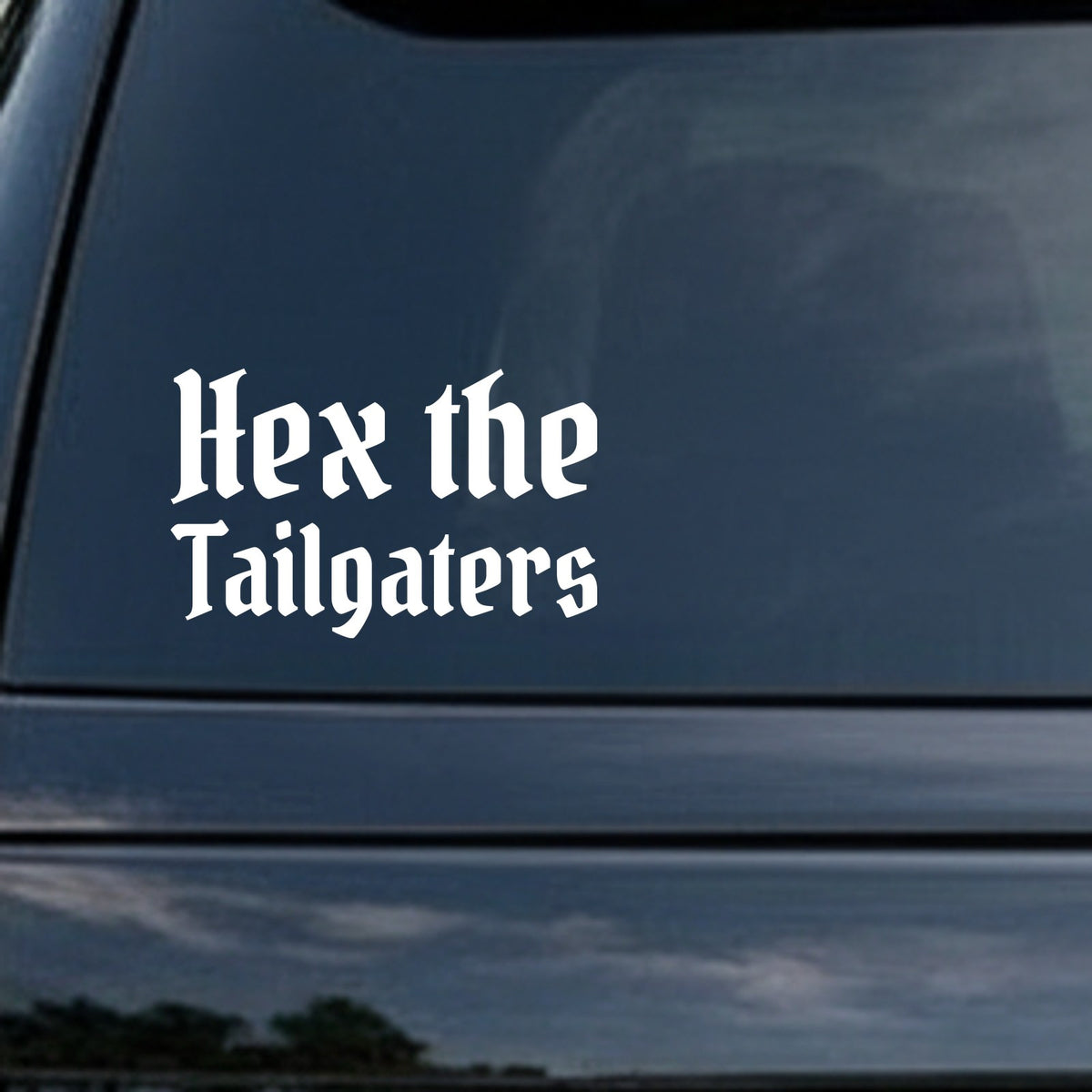 White gothic blackletter lettering reading Hex the Tailgaters on a solid black background in old English style font