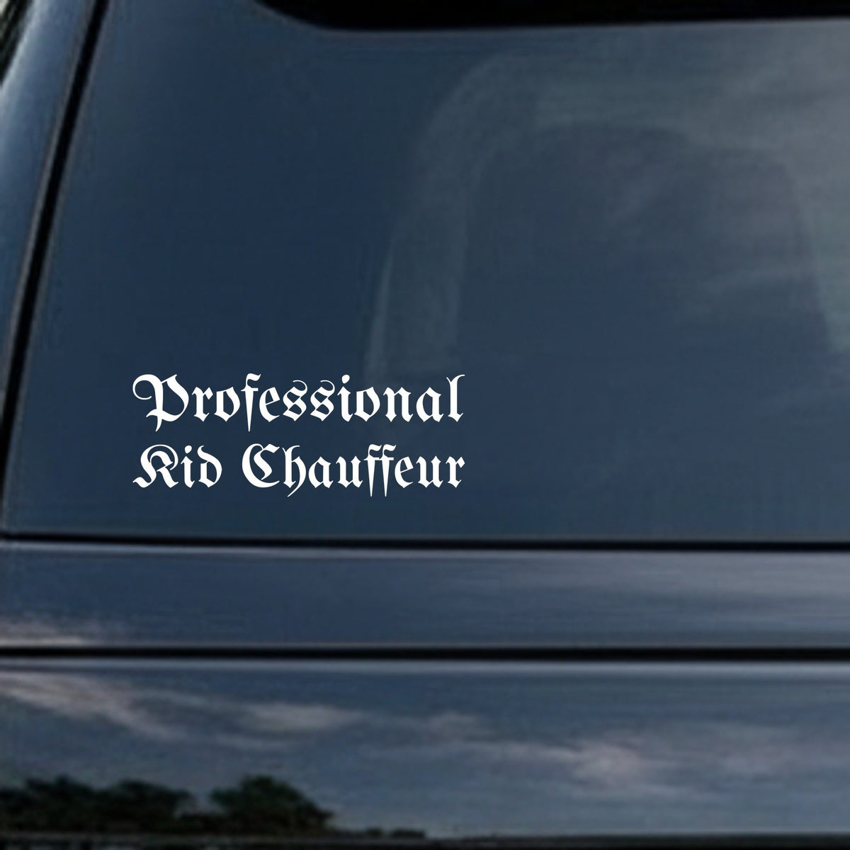 White vinyl decal with the words Professional Kid Chauffeur in gothic blackletter Old English font on a black background.