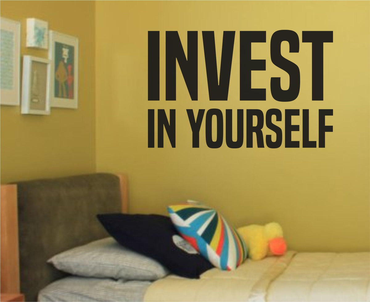 Black vinyl wall decal with the motivational phrase Invest in Yourself in simple, bold lettering on a white background.