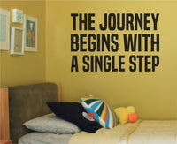 Black vinyl wall decal of the motivational quote The Journey Begins With a Single Step on a white background in bold lettering