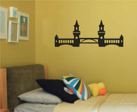 Black silhouette vinyl wall decal of a Berlin landmark bridge with two towers and arches in a minimalist style on white background.