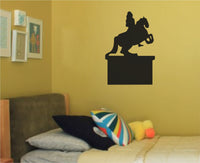 Black silhouette vinyl wall decal of an equestrian statue on a pedestal, showing a rider on a rearing horse in a simple graphic style