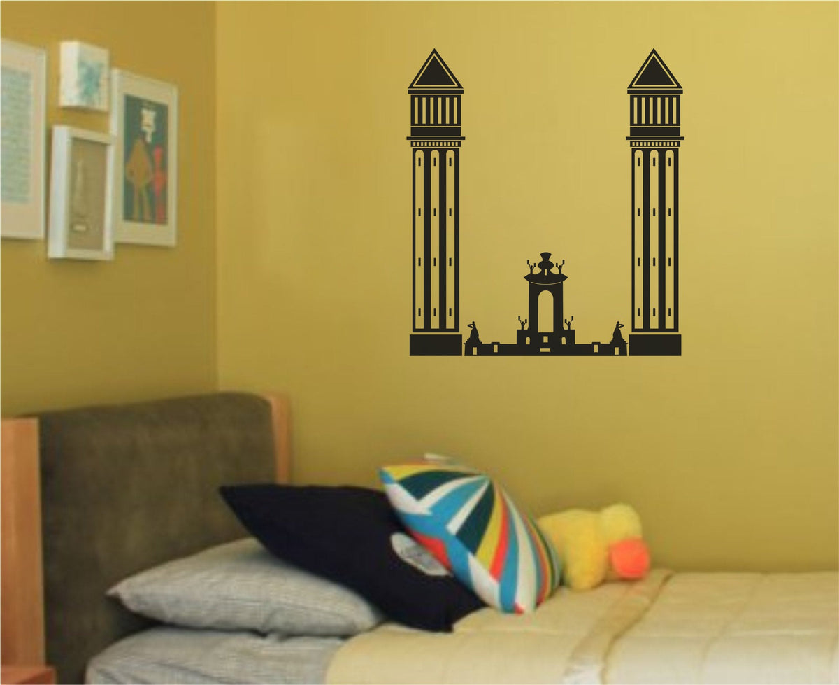 Black silhouette wall decal of two tall towers and a central arched structure representing Barcelona landmarks in minimalist style