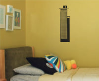Black silhouette vinyl wall decal of a tall modern Frankfurt skyscraper with a grid of windows and a square top structure