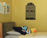 Black silhouette of a modern Munich landmark building with horizontal white stripes on a plain background in graphic style.