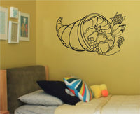 Black silhouette wall decal of a cornucopia filled with pumpkins, grapes, apples, corn, carrot, and other vegetables