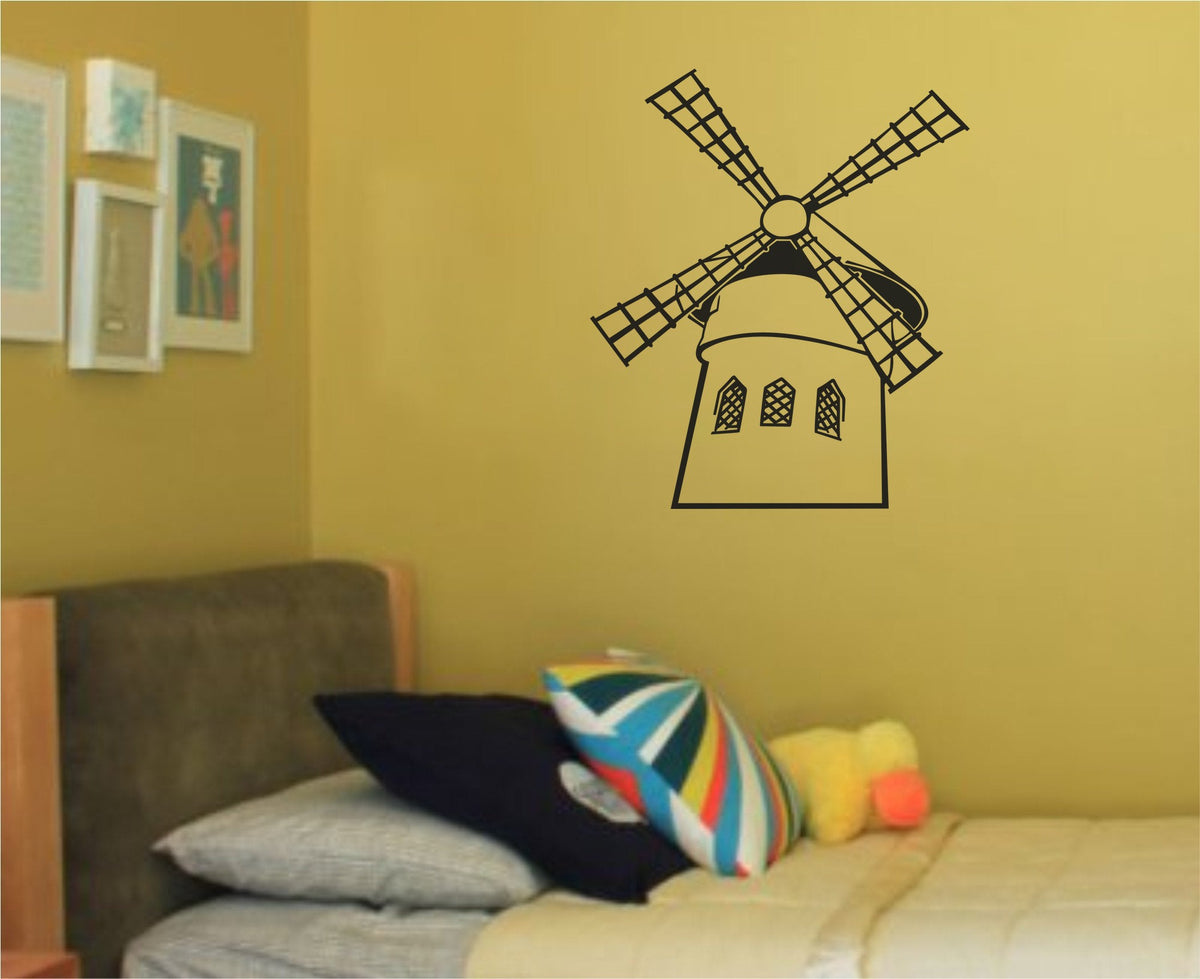 Black silhouette illustration of a Paris windmill with lattice windows and large angled blades on a white background.
