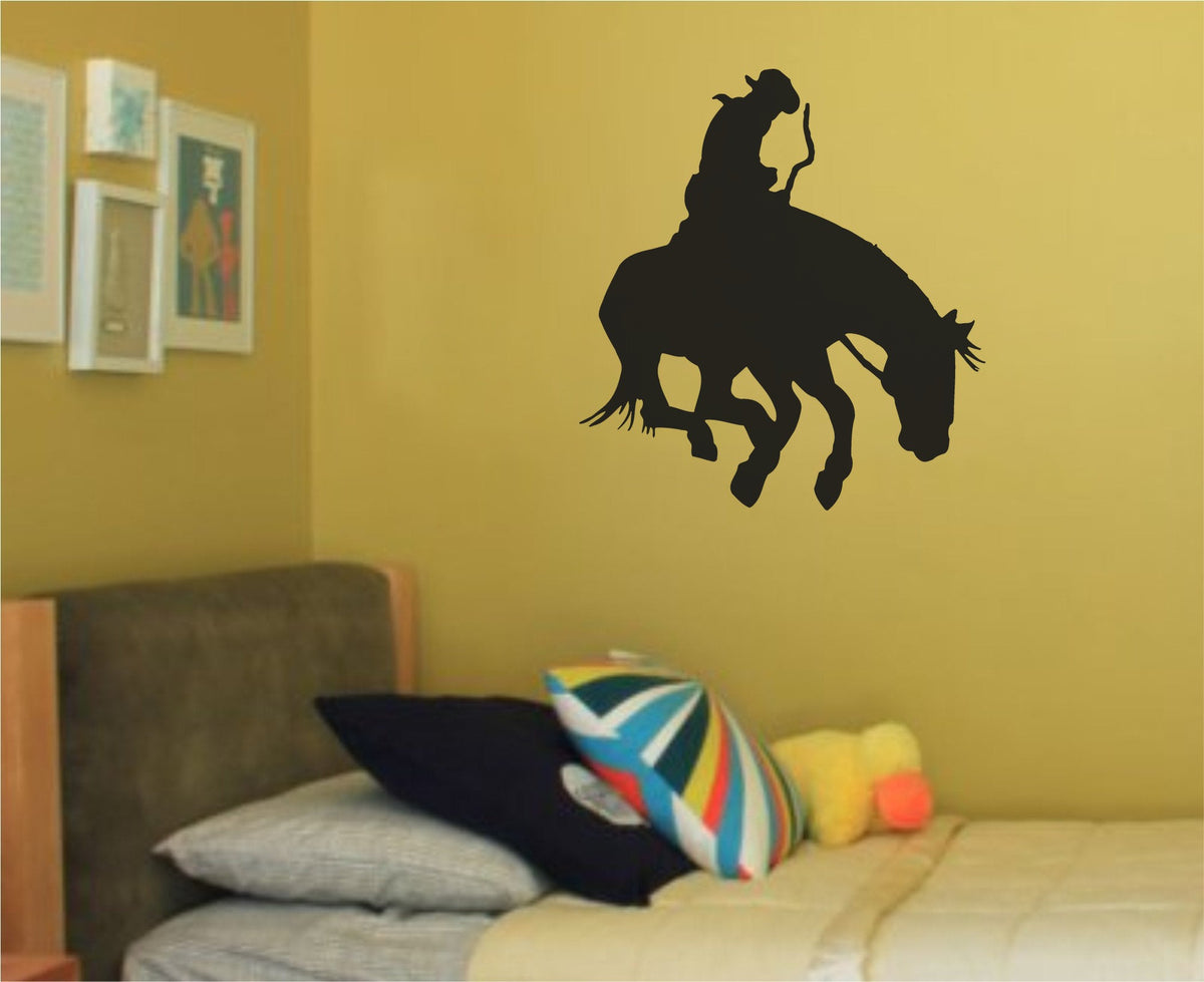 Black silhouette of a rodeo bull rider holding on to a bucking horse in mid-motion, simple bold style on white background.