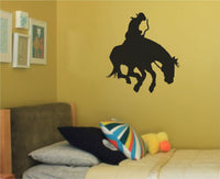 Black silhouette of a rodeo bull rider holding on to a bucking horse in mid-motion, simple bold style on white background.