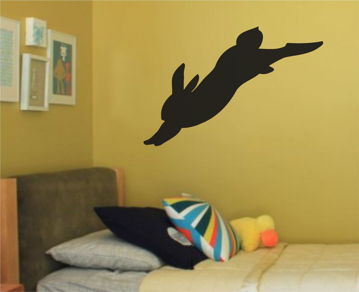 Black silhouette of a rabbit leaping horizontally with ears back in a minimalist vinyl decal style
