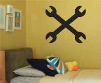 Black silhouette of two crossed wrenches forming an X shape on a white background in a bold simple style.