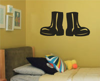 Black silhouette illustration of a pair of work boots side by side with white highlights on a white background
