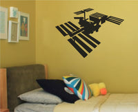 Black silhouette of a space station with solar panels, detailed structure in a clean, modern style on white background.