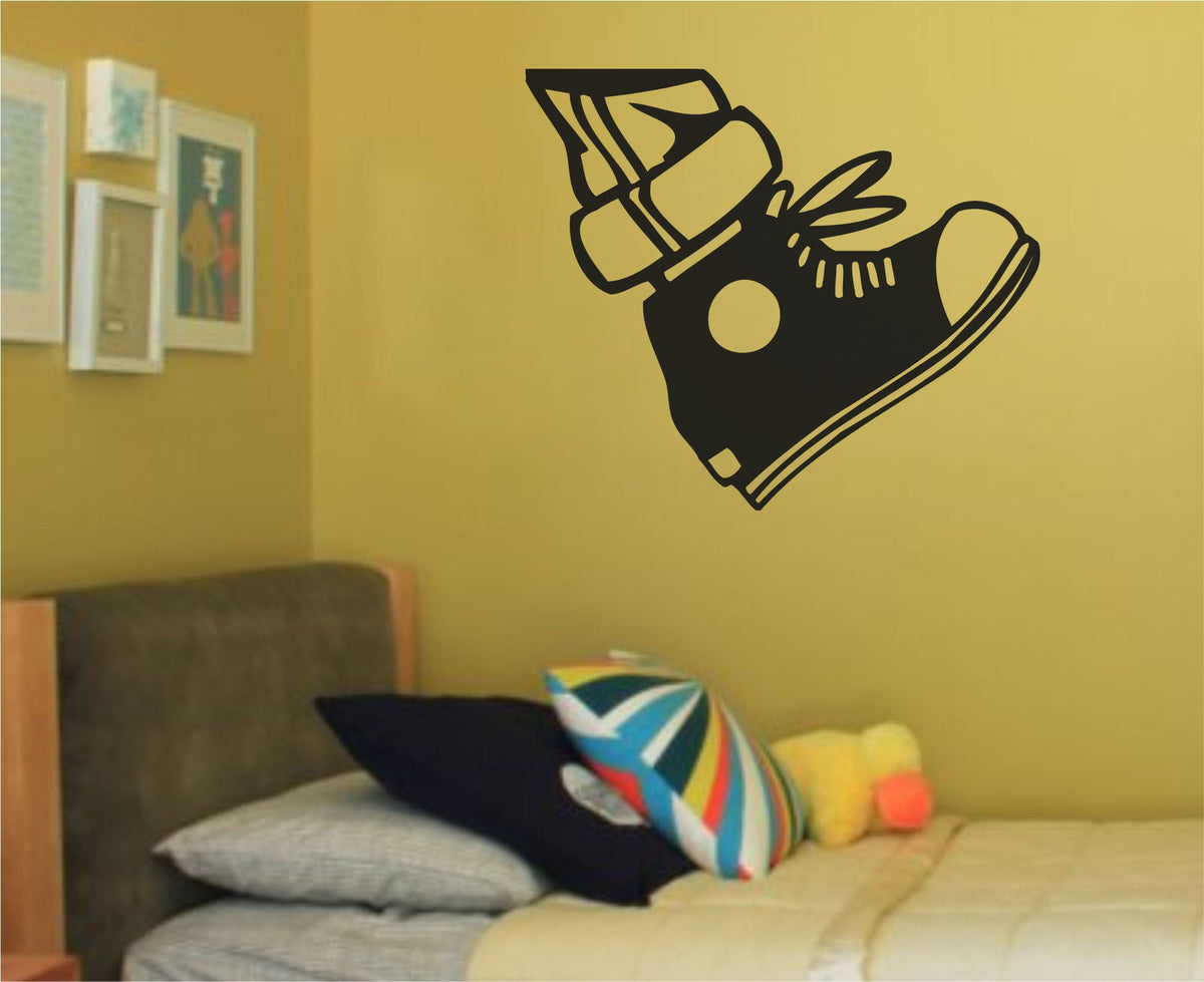 Black and white silhouette of a high top sneaker with laces and a circular patch in a bold vinyl wall decal style